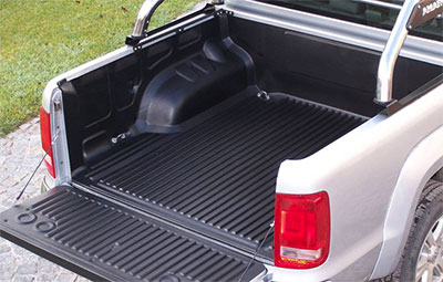 Under Rail bed liner on a double cab pickup with roll bars